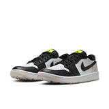 Pair of black, white, and green sneakers on a white background