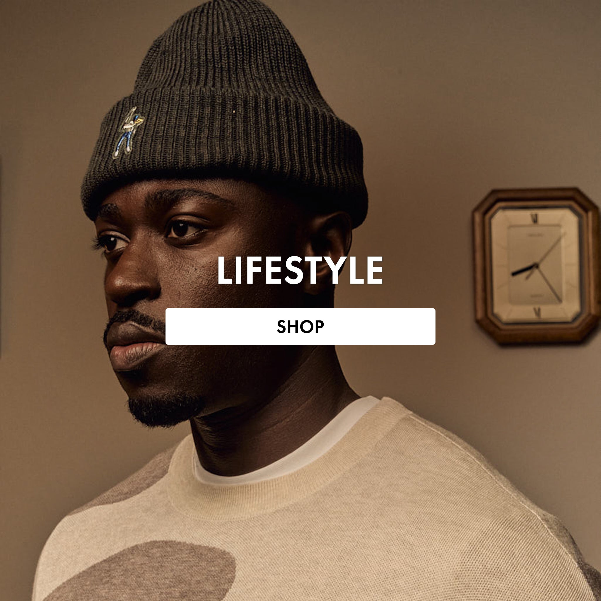 Man wearing a knit beanie with a clock on the wall, featuring 'Lifestyle Shop' text.