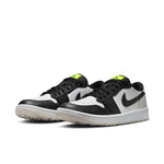 Pair of black, white, and green sneakers on a white background