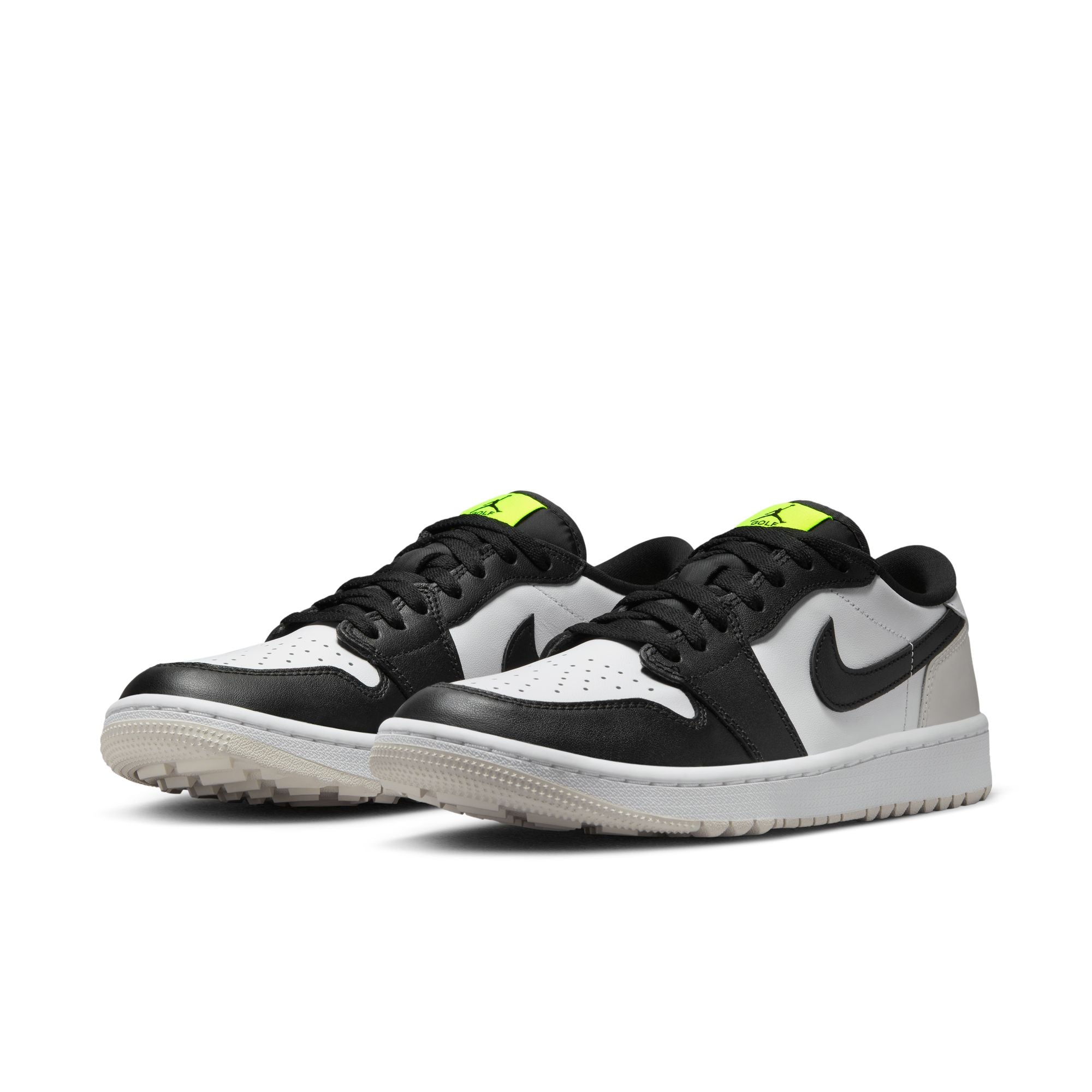 Pair of black, white, and green sneakers on a white background