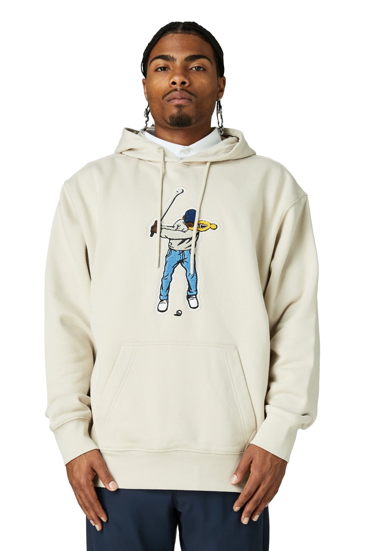 Man wearing a beige hoodie with a graphic design on a white background