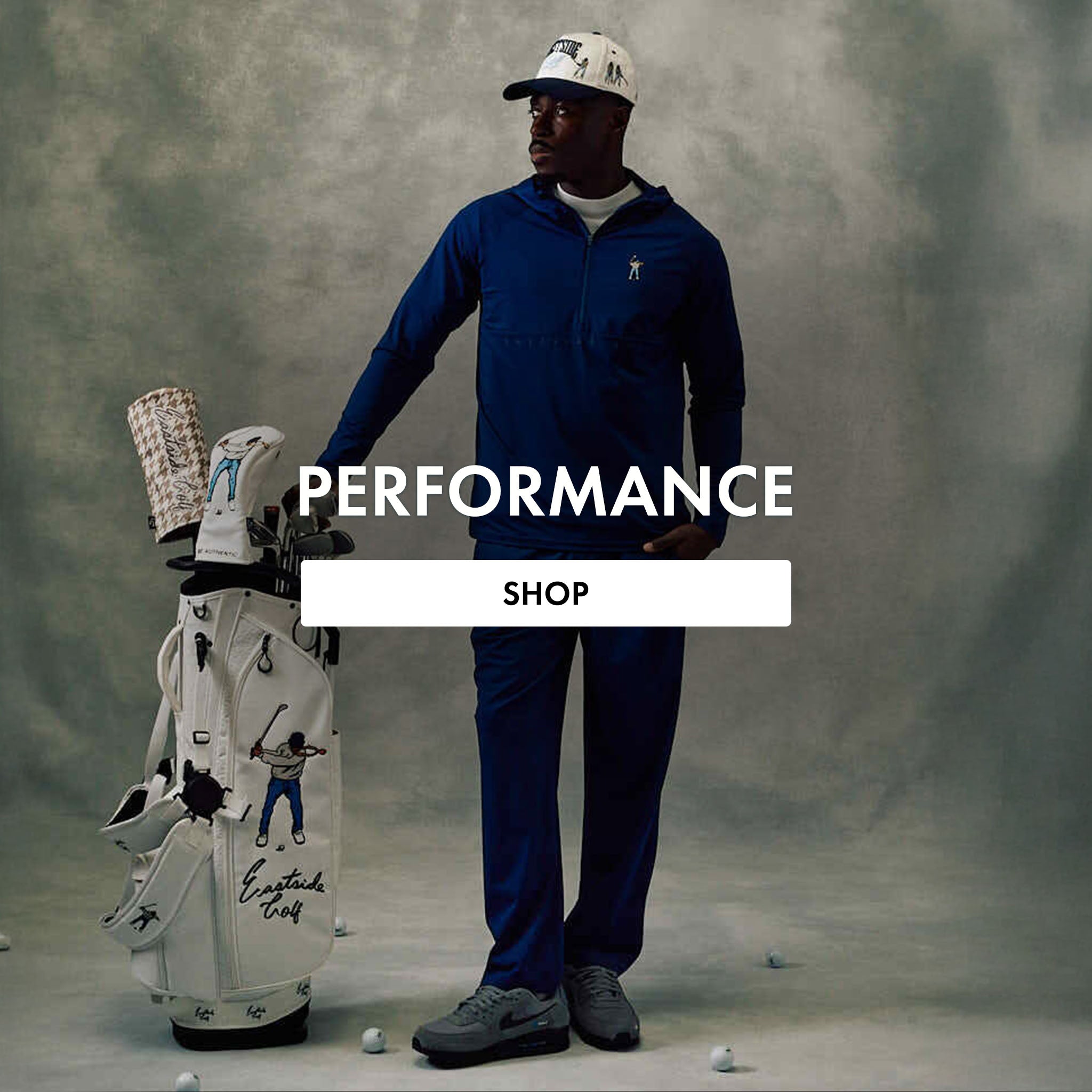 Man in blue golf outfit with golf bag and clubs on gray background